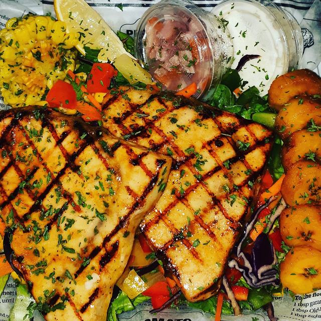 Grilled fish plate with salad and sides